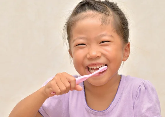 little girl brushing her teeth