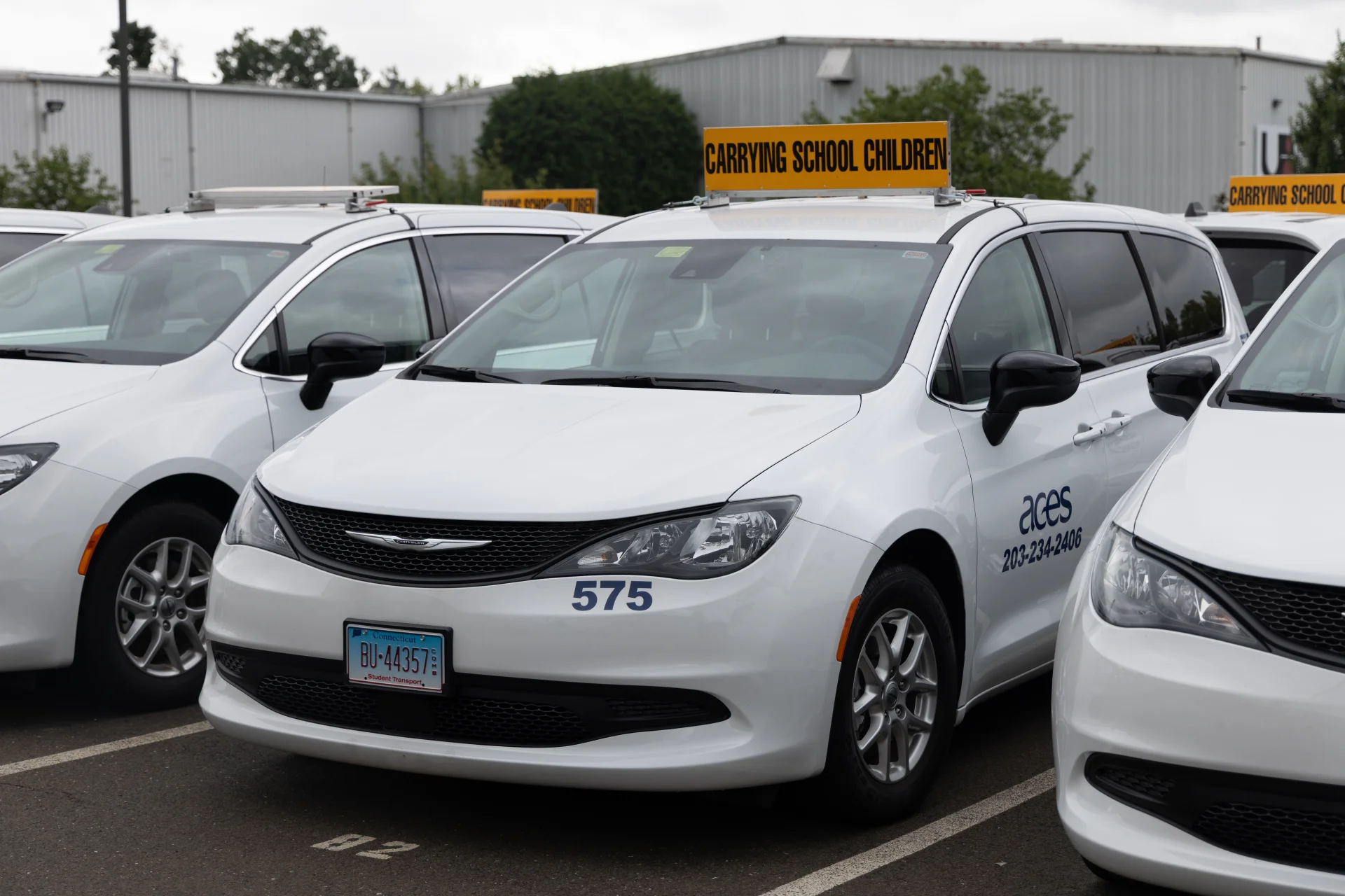 white ACES transportation minivans