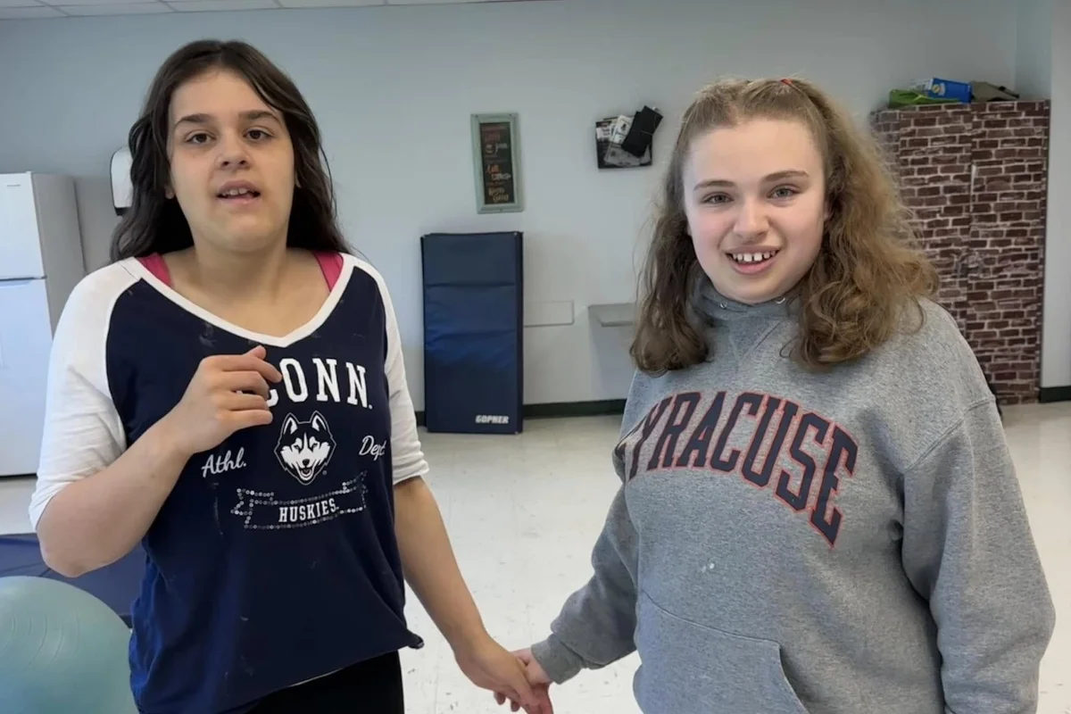 two students holding hands