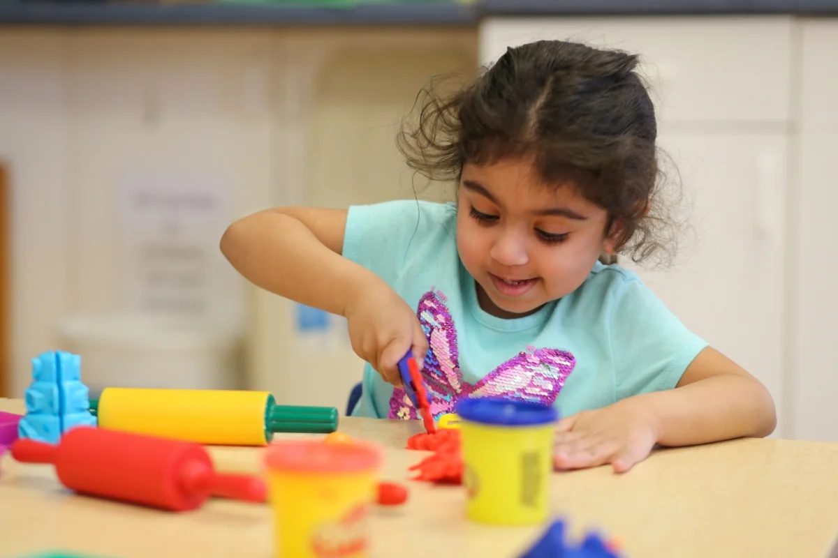 preschool student playing with playdough