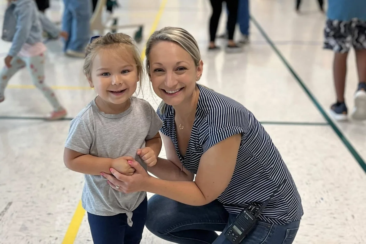 Village School teacher and student smiling