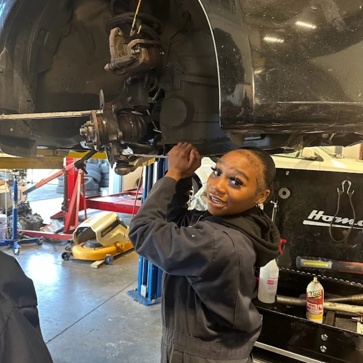 student working on a car