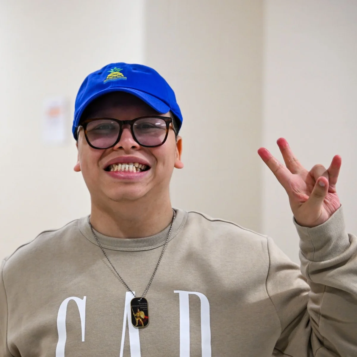 Whitney Academy student holding up a peace sign