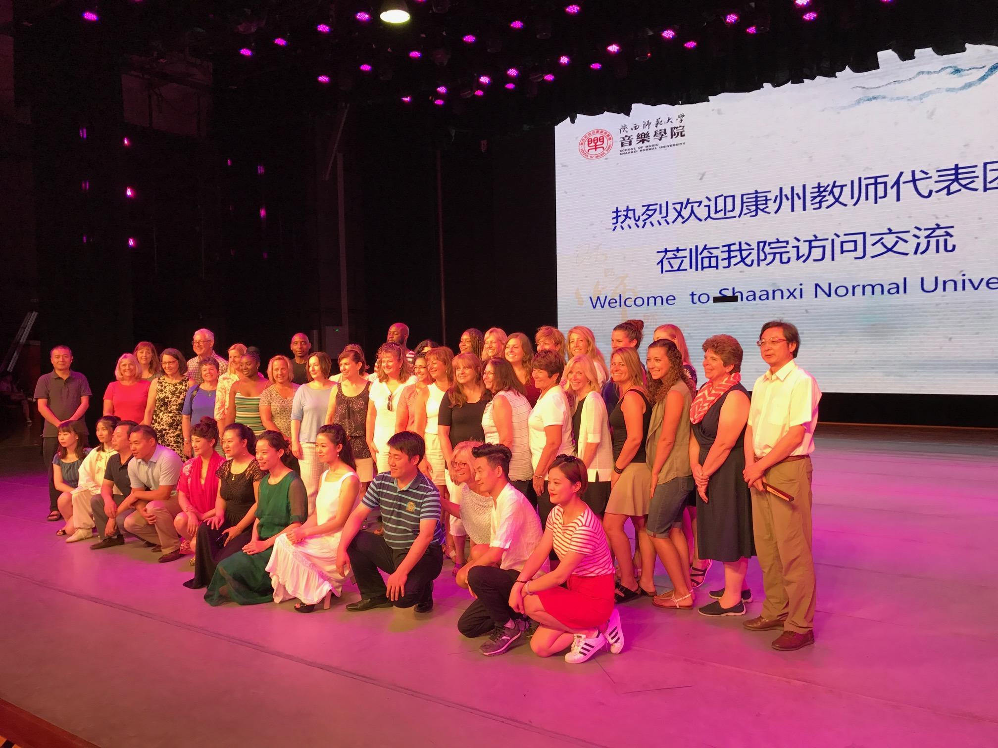 Educators from the field study pose for a photo with staff from Shaanxi Normal University. 