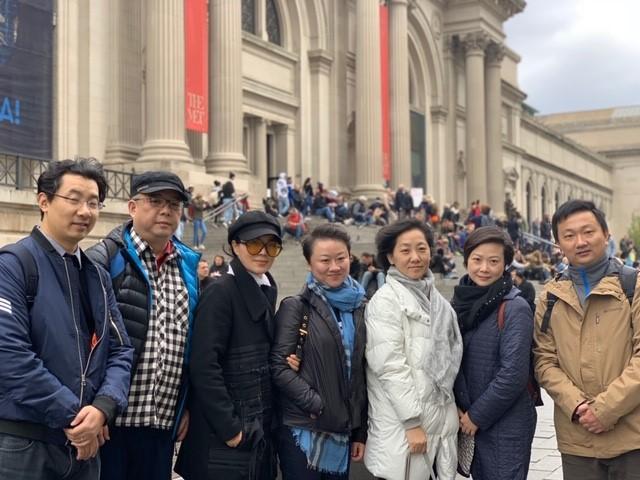 The Visiting Scholars team poses for a photo in front of the MET museum in NY.