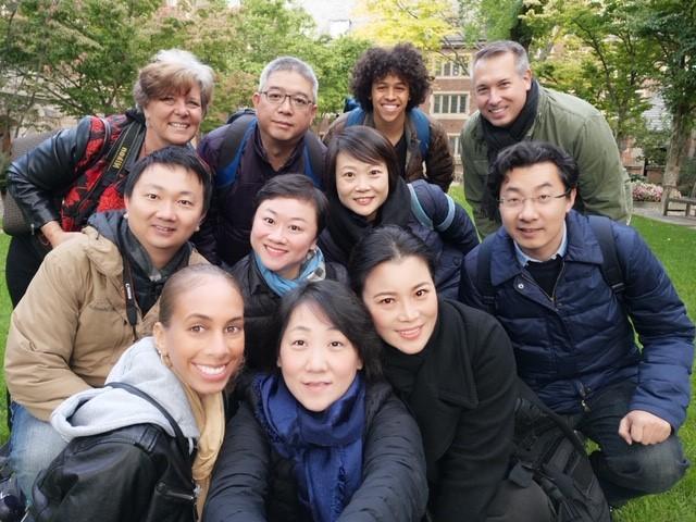 The Visiting Scholars team poses for a photo in a natural area.