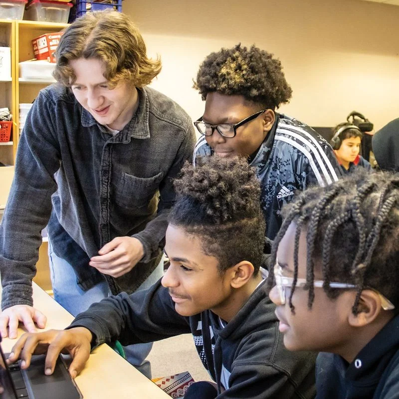 4 students surrounding a computer